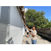 SPHA team members painting house.