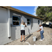 SPHA team members painting house.