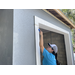 SPHA team member painting house.