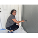 SPHA team member painting house.