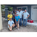 SPHA team smiling in front of Habitat for Humanity house.