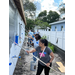 SPHA team members painting house.
