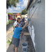 SPHA team members painting side of Habitat for Humanity house.