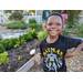 Child in Batman shirt at Jordan Park Community Garden.