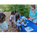 Kids playing with educational activities at Tampa Bay Watch Discovery Center table.