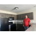 Man standing in kitchen inside The Legacy at Jordan Park.