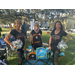 Three former NFL cheerleaders with backpacks at Jordan Park Back to School Event 2023.
