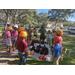 Group of kids and instructor teaching how to rope climb at Jordan Park Back to School Event 2023.