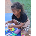 Child wearing pink shoes playing outside at Disston Place Apartments.