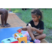 Child with pink shoes playing outside at Disston Place Apartments Back to School Event 2023.