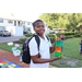 Young boy holding a toy and wearing a backpack at Disston Place Apartments Back to School Event 2023.