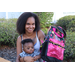 Family with new Encanto themed backpack at Disston Place Apartments Back to School Event 2023.