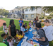 Kids and St. Petersburg Housing Authority (SPHA) team members standing by blue table.