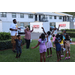United Way Suncoast team and children dancing and jumping outside.