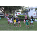 United Way Suncoast team and children dancing in the grass.