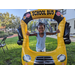 Young girl wearing blue shirt and balloon school bus at Disston Place Apartments Back to School Event 2023.