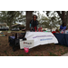 Woman smiling at Kidzonomics table at Very Merry Holiday Party in Jordan Park.