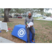 Person standing by St. Petersburg College table at Very Merry Holiday Party in Jordan Park.