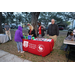 People standing by Pinellas County Job Corps table at Very Merry Holiday Party in Jordan Park.