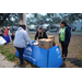 People standing by Metropolitan Ministries table at Very Merry Holiday Party in Jordan Park.