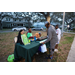 People getting information at table at Very Merry Holiday Party in Jordan Park.