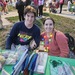 Two people smiling and sitting at table at Very Merry Holiday Party 2023.