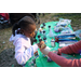 Child making a holiday craft at Very Merry Holiday Party in Jordan Park.