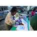 People at pizza table at Very Merry Holiday Party in Jordan Park.