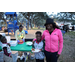 Family at pizza table Very Merry Holiday Party in Jordan Park.