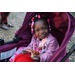 Child smiling with pizza at Very Merry Holiday Party in Jordan Park.