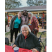 Four people smiling at Very Merry Holiday Party 2023.