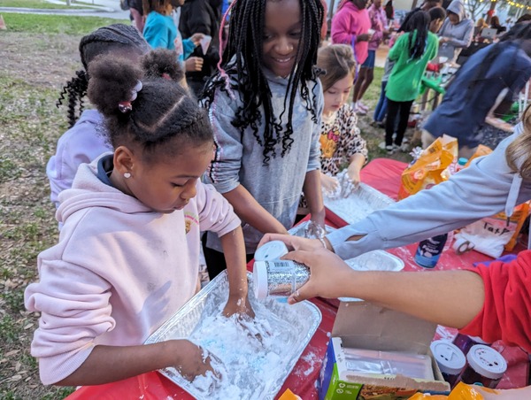 Children playing at Very Merry Holiday Party 2023.