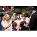 Woman at table with children drawing at Very Merry Holiday Party in Jordan Park.