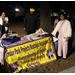People standing by Jordan Park Nostalgic Association, Inc. table at Very Merry Holiday Party 2023 in Jordan Park.