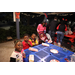 Family at blue table at Very Merry Holiday Party 2023 in Jordan Park.