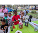 Children adding flavor to snow cones at Very Merry Holiday Party 2023.