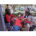 People talking at red table.