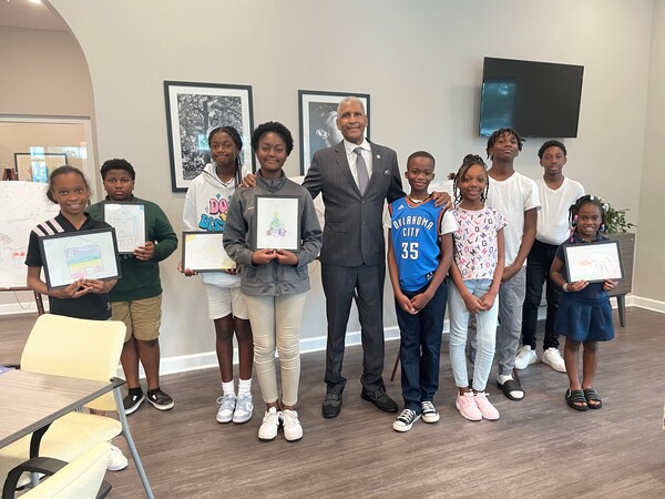 Group of Kid\'s Art Contest winners with SPHA President/CEO Michael Lundy at The Legacy at Jordan Park.