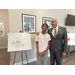 SPHA Kid's Art Contest winner for the month of November 2024 standing next to their artwork with SPHA President/CEO Michael Lundy at The Legacy at Jordan Park.