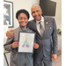 SPHA Kid's Art Contest winner for the month of December 2024 holding their artwork with SPHA President/CEO Michael Lundy at The Legacy at Jordan Park.