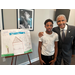 SPHA Kid's Art Contest winner for the month of January 2024 standing next to their artwork along with SPHA President/CEO Michael Lundy at The Legacy at Jordan Park.