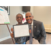 SPHA Kid's Art Contest winner for the month of March 2024 holding their artwork with SPHA President/CEO Michael Lundy at The Legacy at Jordan Park.