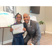SPHA Kid's Art Contest winner for the month of April 2024 holding their artwork with SPHA President/CEO Michael Lundy at The Legacy at Jordan Park.