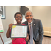 SPHA Kid's Art Contest winner for the month of August at 2024 holding their artwork with SPHA President/CEO Michael Lundy at The Legacy at Jordan Park.