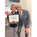 SPHA Kid's Art Contest winner for the month of September 2024 holding their artwork with SPHA President/CEO Michael Lundy at The Legacy at Jordan Park.