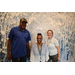 Three SPHA team members in front of winter backdrop inside The Legacy at Jordan Park building during SPHA Winter Wonderland event.