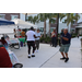 Residents and SPHA staff dancing on the sidewalk outside The Legacy at Jordan Park building during SPHA Winter Wonderland event.