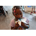 Young girl eating blue cupcake inside of The Legacy at Jordan Park building during SPHA Winter Wonderland event.