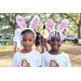 Two girls wearing bunny ears at Spring Family Picnic event in Jordan Park on March 26, 2024.