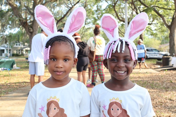 Two girls wearing bunny ears at Spring Family Picnic event in Jordan Park on March 26, 2024.